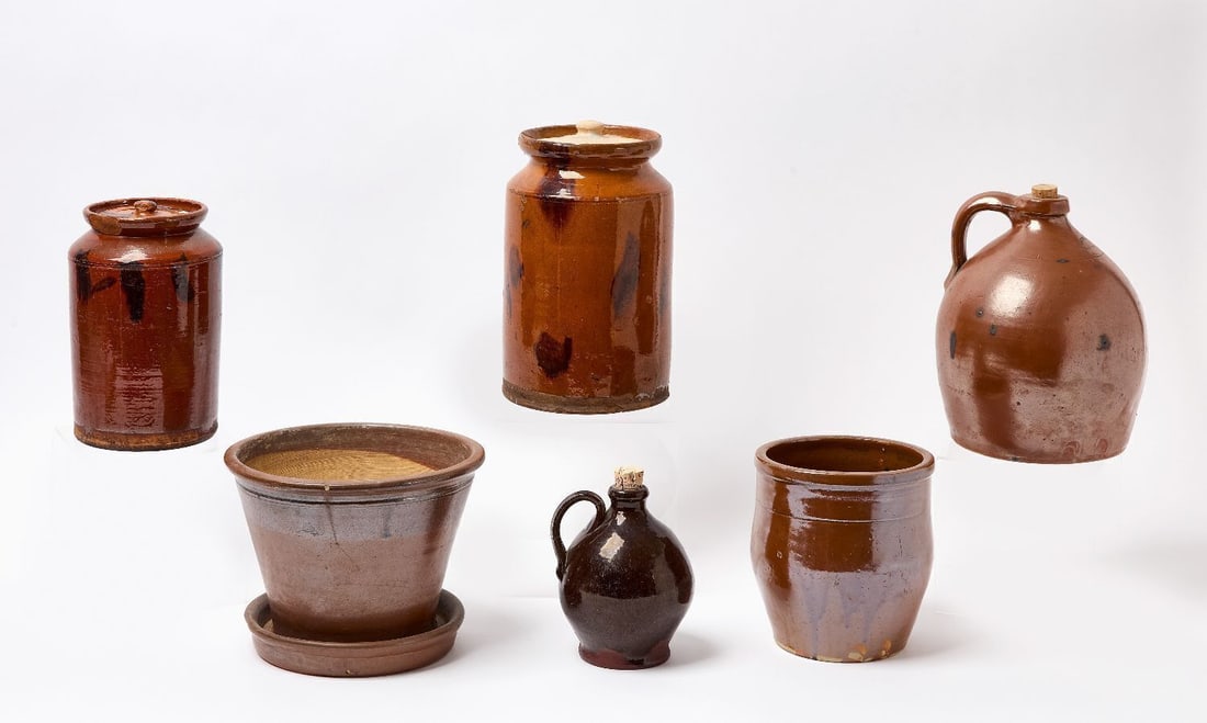 Six Pieces of Norwalk Redware Pottery: Six pieces of Norwalk (Connecticut) redware pottery. With the smallest jug includes a shard from the foundry that matches up with the base. 19th century. Smallest: H 6-3/4 in. Largest: H 10-3/4 in.