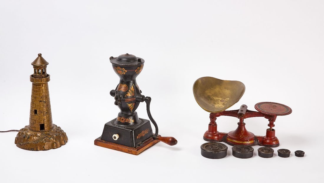 Coffee Mill, Lighthouse Lamp, and Scale: Group of iron coffee grinder, scale with weights, and a lighthouse table lamp. American, early 20th century. Grinder: H 12 in. W 6-3/4 in. D 6-1/4 in. Scale: H 8 in. L 14 in. Lamp: H 12-1/2 in. D 7