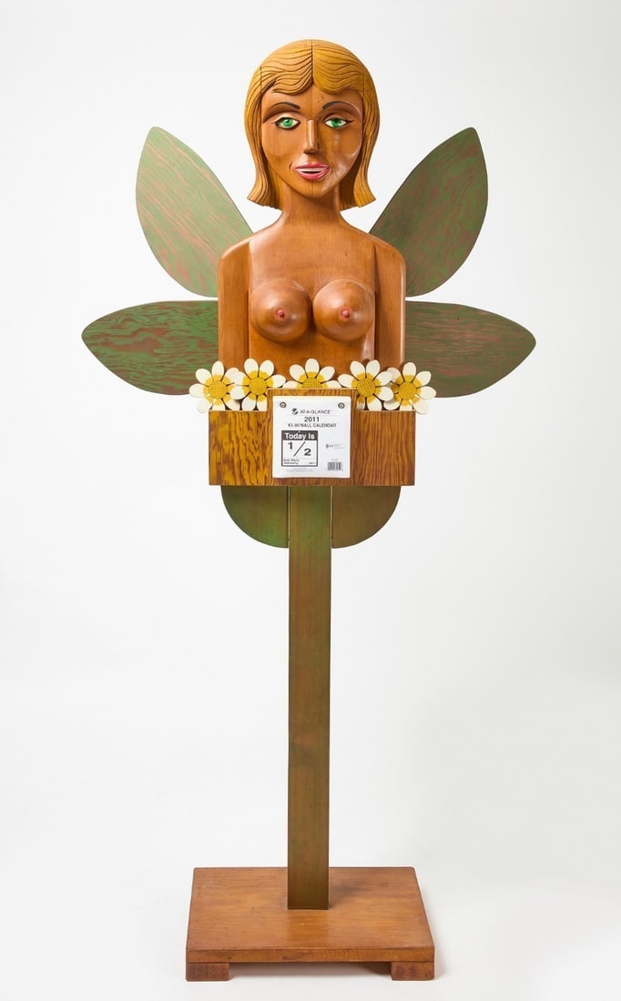 Leo Jensen - 'Calendar Girl': Leo Jensen (American, 1926-2019). "Calendar Girl." Carved wood with polychrome hand-painted decoration, depicting a nude female bust with green-painted wing forms to the sides, incorporating