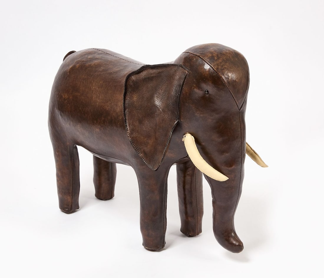 Dimitri Omersa - Leather Elephant Footstool for Abercrombie & Fitch: Dimitri Omersa (Omersa & Co., England). Leather elephant-form footstool, multi-piece sewn leather construction with white leather tusks, downturned trunk, and glass eyes. Retailed by Abercrombie