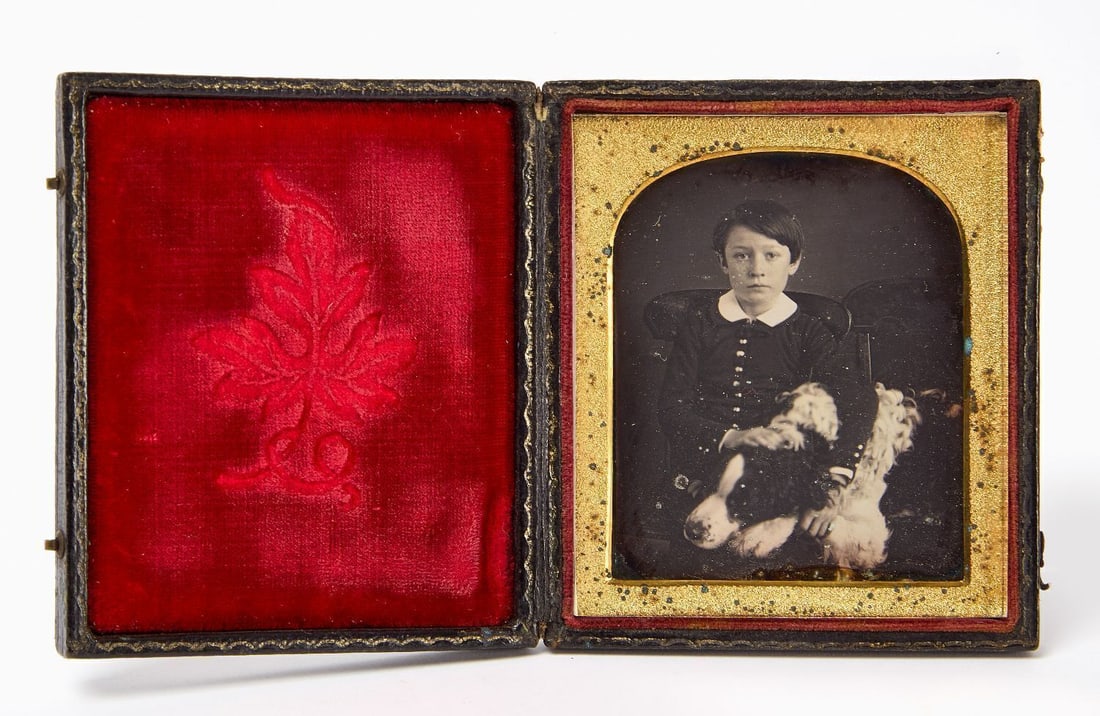 Daguerreotype of a Boy with Dog: Sixth plate daguerreotype of a boy with his large dog on his lap. Housed in a full leatherette case with repaired spine. American, circa 1855. Case: H 3-3/4 in. W 3-1/4 in. 
