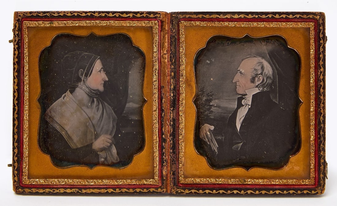Pair of Daguerreotypes of Painted Folk Art Portraits:  1/6 plate pair of daguerreotypes of painted folk art portraits. Depict a husband and wife facing each other in a double leatherette case. American, circa 1845. Case: H 3-5/8 in. W 3-
