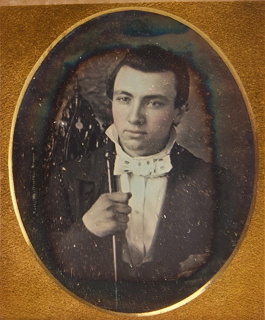 Daguerreotype of Pyotr Ilyich Tchaikovsky: 1/9 plate Daguerreotype portrait of Russian composer and conductor Pyotr Ilyich Tchaikovsky as a young man. Holding a conductor's baton. Plain oval gilt mat with full leather case with clasp, and 