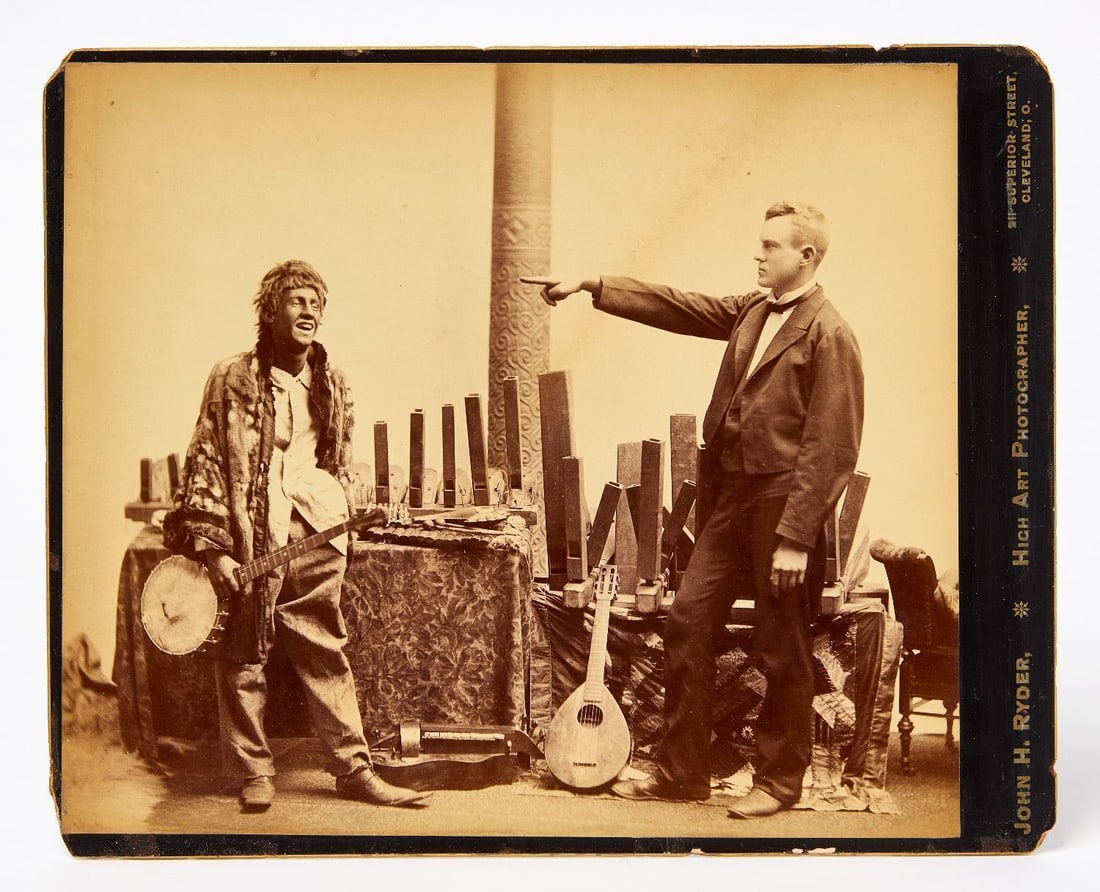 John H. Ryder - Banjo Player with Pointing Man: John H. Ryder (American, 1826-1904), albumen photograph depicting two men in an interior setting with musical instruments and what appear to be carved wooden whistles of various sizes. On the left, a 