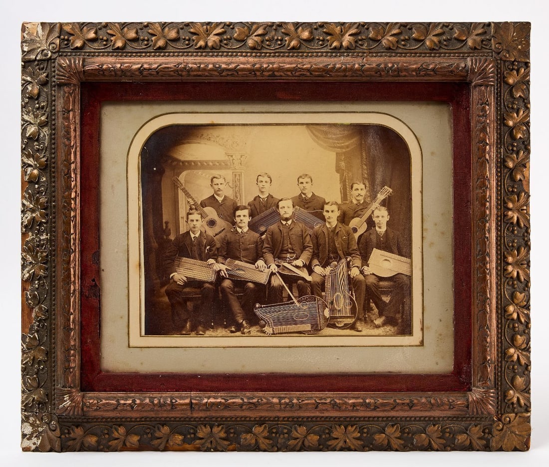 Large Albumen Photograph Men's String Band: Large albumen mounted photograph on board showing a 9-member men's string band. The men all hold either a zither or guitar. Period frame. American, circa 1870-90. Frame: H 21 in. W 25 in., Mat Ope