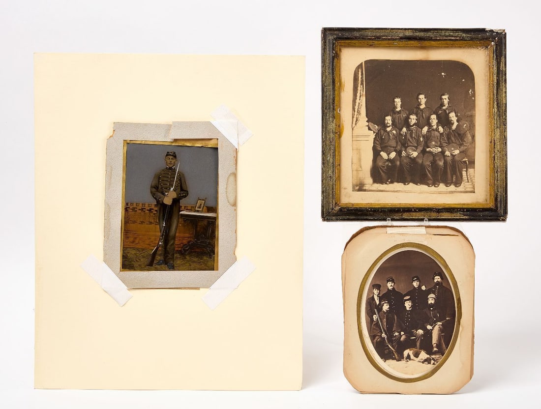 Three Early American Military-Related Photographs: Three military related photographs. 7x8-1/2 in. (full plate) tintype with a full-length portrait of a solider in uniform holding a firearm, a smaller framed photograph is shown on the table, all with 