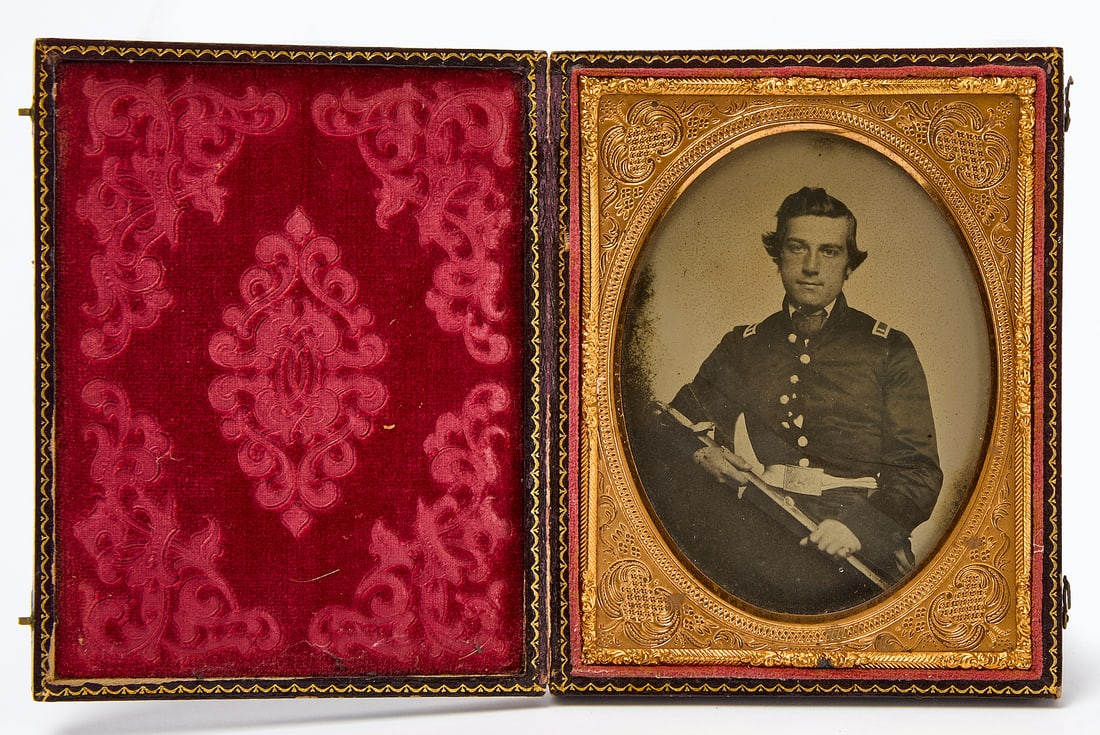 Quarter Plate Ambrotype of a Soldier with Sabre: Quarter plate clear glass ambrotype portrait of a seated man in uniform holding a sabre. Housed in a full leatherette case. American, circa 1860-70. Case: H 4-5/8 in. W 3-3/4 in. 