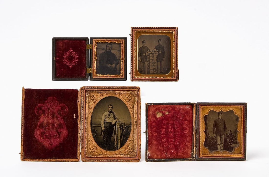 Four Civil War Era Cased Tintypes: Four Civil War era (or slightly post-war) cased tintype photographs. One 1/4 plate of a man standing next to an American flag draped over a table. Two 1/6 plate images - one of a soldier in uniform wi