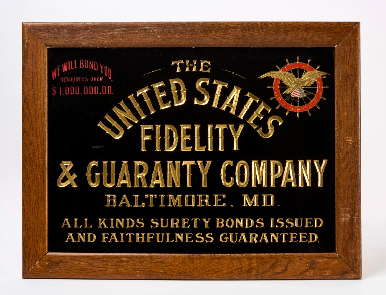 United States Fidelity and Guaranty Company Insurance Sign: Single-sided gold leave under glass sign with carved lettering for The United States Fidelity & Guaranty Company (Baltimore, MD). Bearing phrases 'We Will Bond You Resources Over $1,000,0
