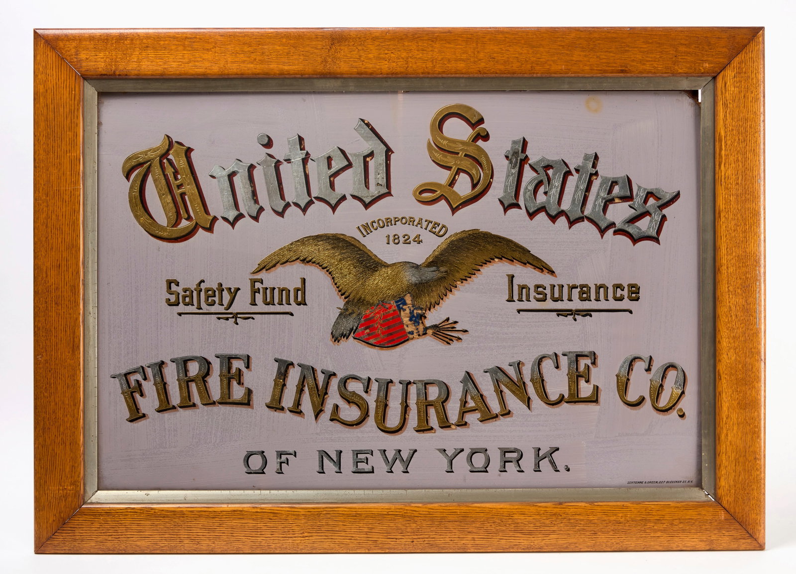 United States Fire Insurance Company Trade Sign: United States Fire Insurance Company of New York trade sign. Single-sided reverse paint on glass. Period likely original wood frame. Bears a spread-wing eagle clutching patriotic shield graphic in the