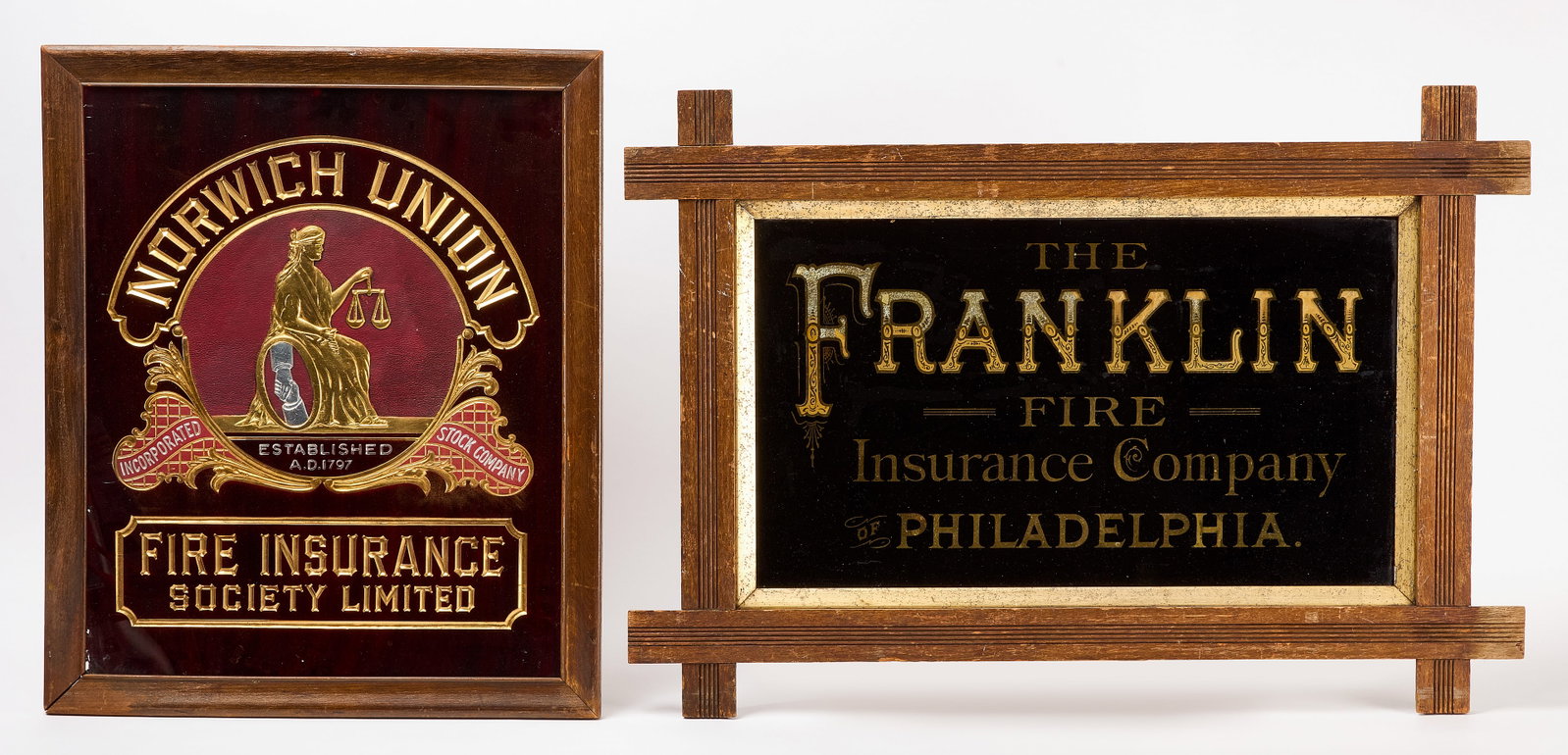 Two Early Glass Insurance Signs: Two early glass insurance signs. Norwich Union Fire Insurance with Lady Justice graphic. Together with The Franklin Fire Insurance Company of Philadelphia sign with stylized text. Both in likely