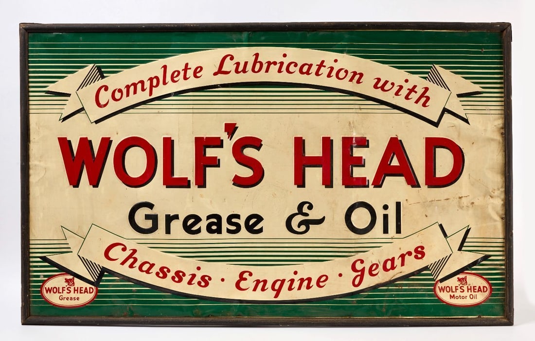 Wolf's Head Grease and Oil Sign: 'Complete Lubrication with Wolf's Head Grease & Oil. Chassis - Engine - Gears'. Single-sided embossed tin. Period likely original wood frame. PA, circa 1920-30. H 37-1/2 in. W 61