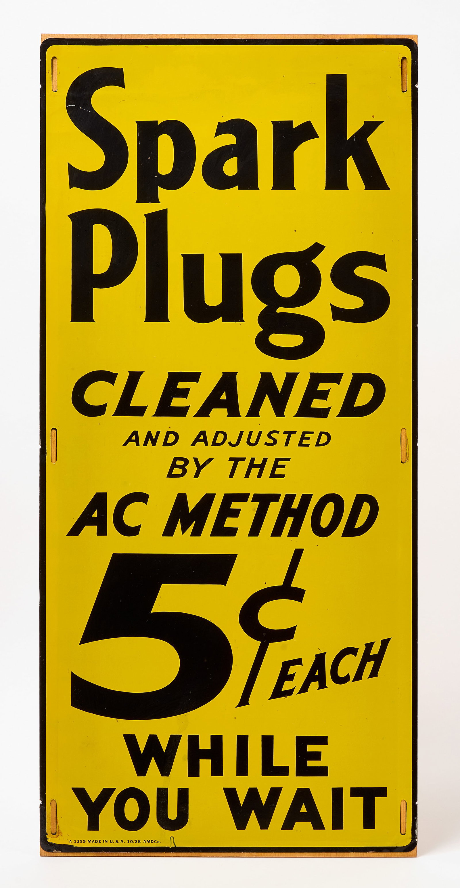 Spark Plugs Cleaned AC Method Sign: Single-sided tin sign. 'Spark Plugs Cleaned and Adjusted by the AC Method 5 cents Each While You Wait'. American, dated 1938. H 29-3/4 in. W 13-3/4 in.