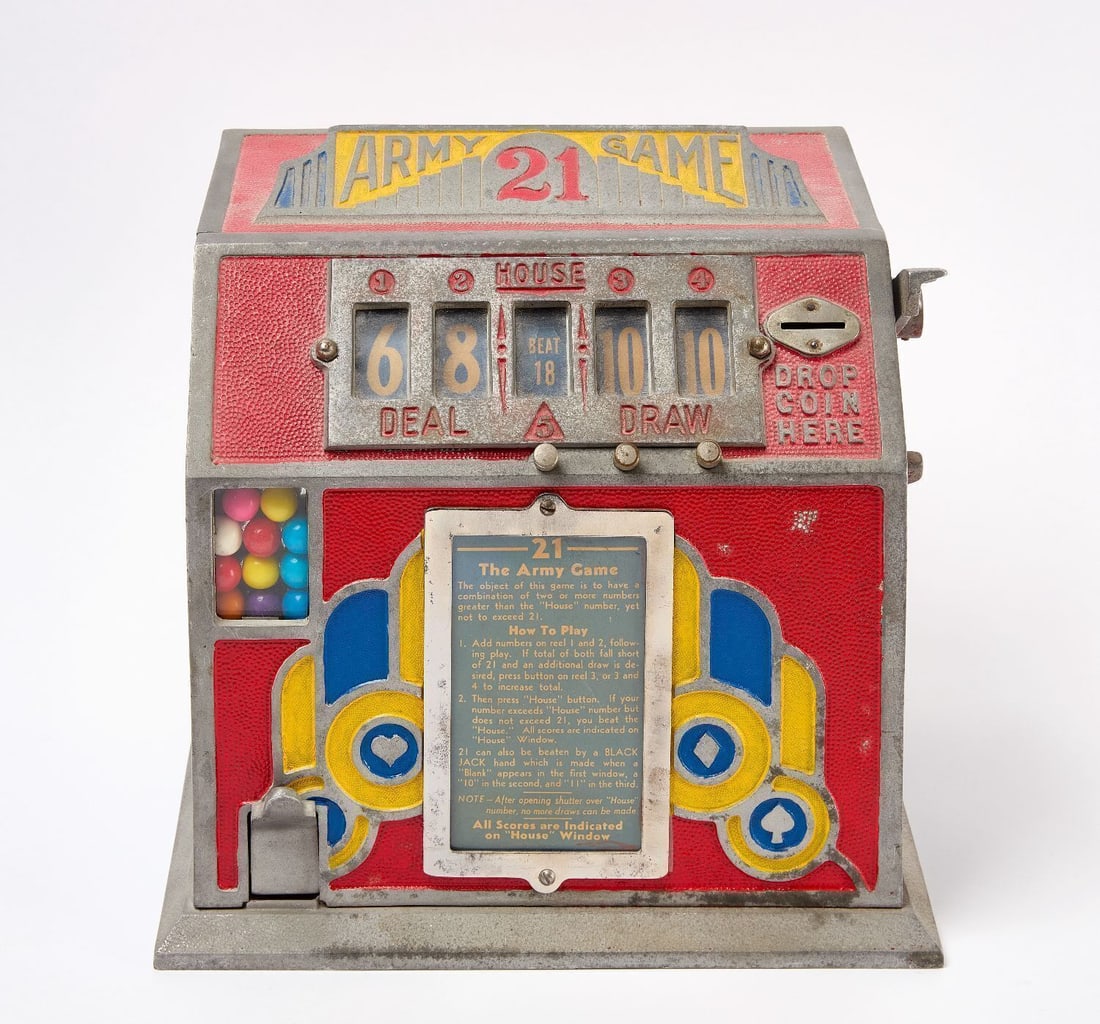 Army Game Blackjack Coin-Op Trade Simulator: 'Army Game 21' coin-operated countertop trade simulator with 5-reel Blackjack game. Dispenses gumball upon successful win. Metal with original paint. American, circa 1940. H 11-1/2 in. W 12 in