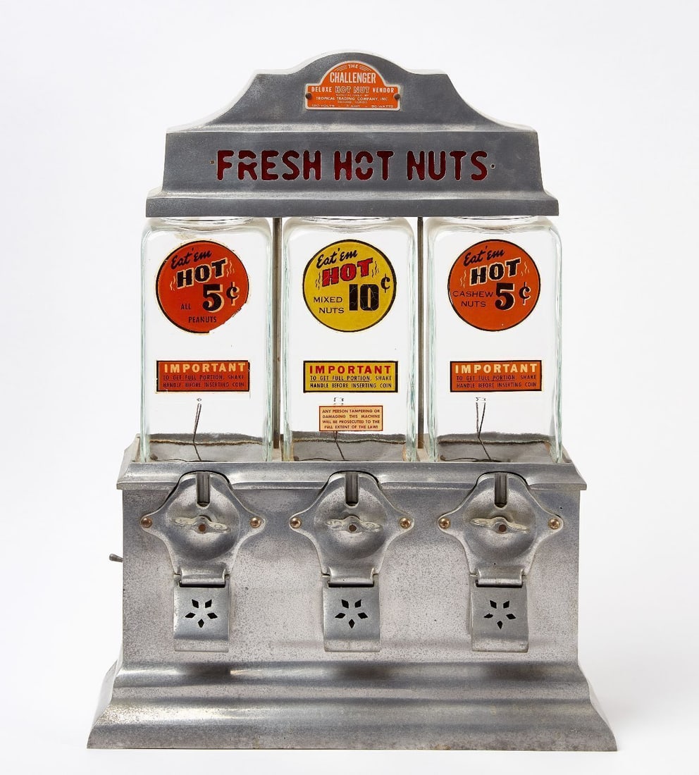 The Challenger Deluxe Hot Nut Vendor: The Challenger Deluxe Hot Nut Vendor with lighted sign that reads 'Fresh Hot Nuts'. Glass canisters with applied decals. Base and top in polished nickel. Manufactured by the Tropical Trading