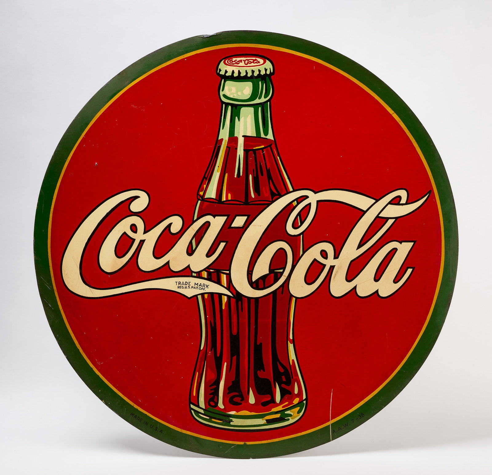 Large Coca Cola Graphic Sign: Large Coca Cola sign with bottle graphic. Single-sided lithograph on tin. American, dated 1938. Dia 45-1/2 in.