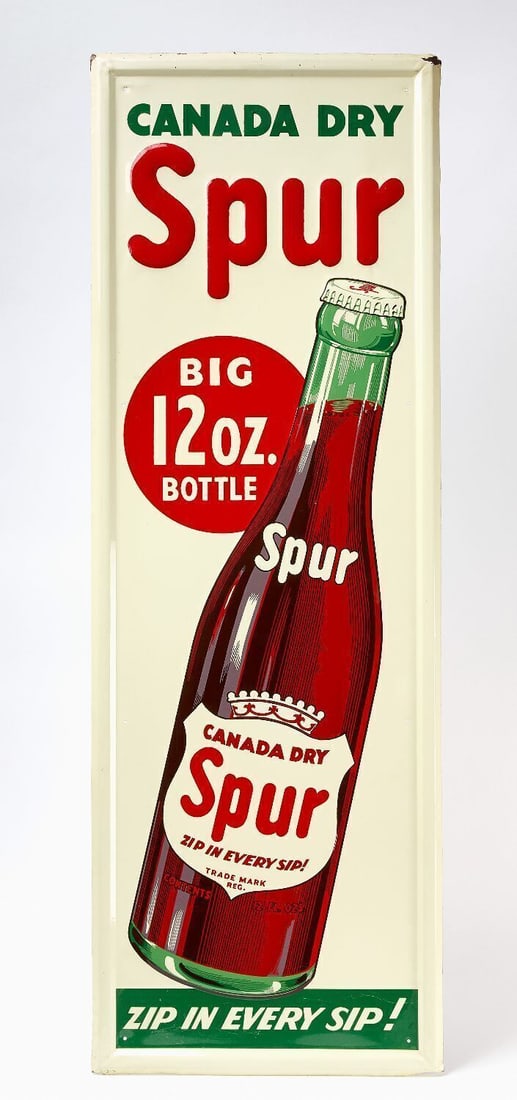 Canada Dry Spur Sign: Canada Dry 'Spur - Big 12 oz. Bottle' vertical sign. Single-sided embossed tin. Features large Spur bottle graphic and on bottom phrase 'Zip In Every