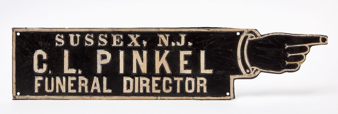 C. L. Pinkel Funeral Director 'Pointing Hand' Sign: Sussex NJ C. L. Pinkel Funeral Director single-sided embossed tin sign with pointing hand. American, circa 1920. H 6-1/2 in. L 28 in.