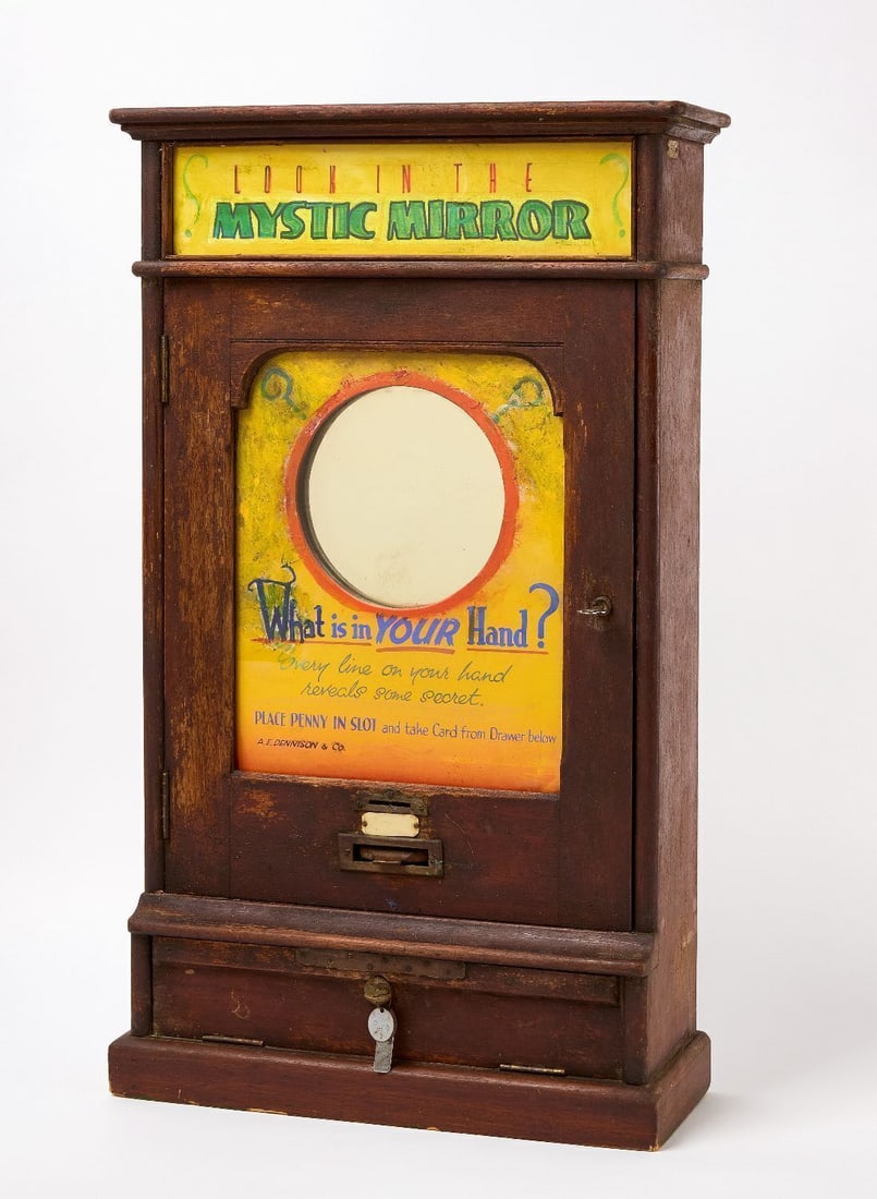 Mystic Mirror 1-Cent Fortune Teller: 'Mystic Mirror' 1-cent (penny) coin-op fortune teller by A. E. Dennision & Co. The mechanism ejects a card 'Whom Shall I Marry?' with various anecdotes on the reverse of each