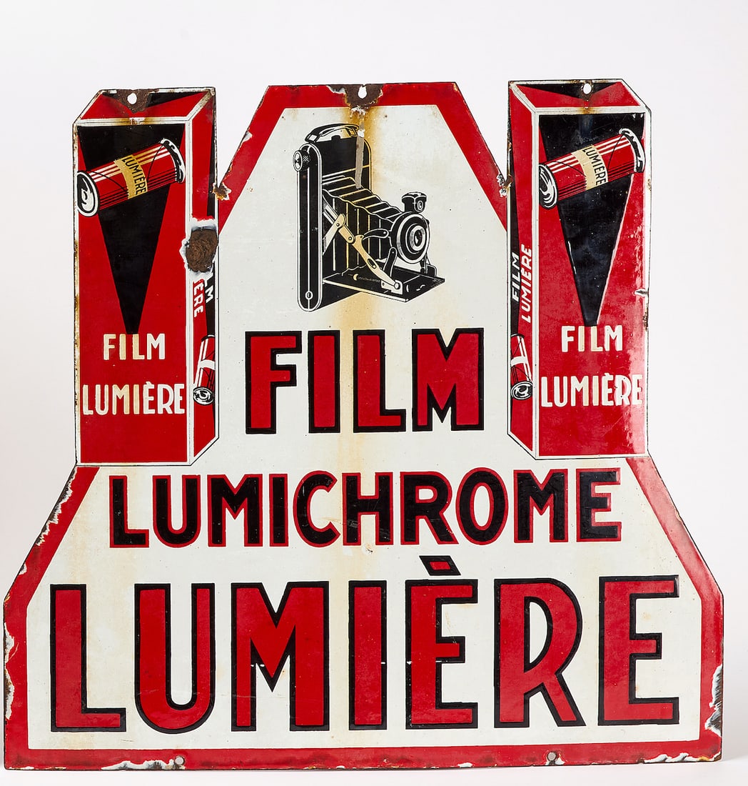 Lumiere Lumichrome Film Sign: Lumiere Lumichrome film sign. Double-sided enamel. France, mid 20th century. H 23-1/4 in. W 24-3/8 in.