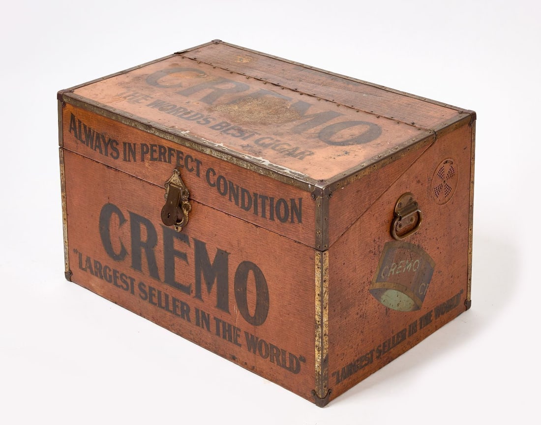 Cremo Cigars Advertising Humidor Trunk: Cremo Cigars trunk-sized humidor with painting to simulate wood grain. Cuba, circa 1920. H 16-3/4 in. W 28-1/2 in. D 18-1/2 in. Provenance: Collection of Paul and Dodi Algiers (Massachusetts, USA).