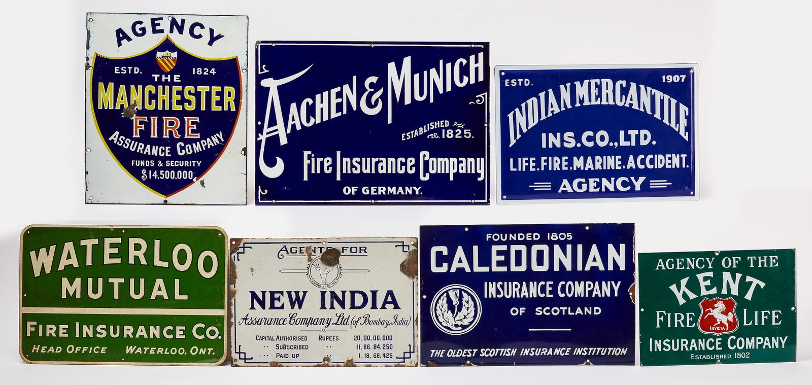 Seven International Insurance Signs: Group of seven non-US (international) insurance signs. Enamel on metal. Includes Kent Fire Life Insurance Company, Indian Mercantile Insurance Co, Caledonian Insurance Company of Scotland, New India