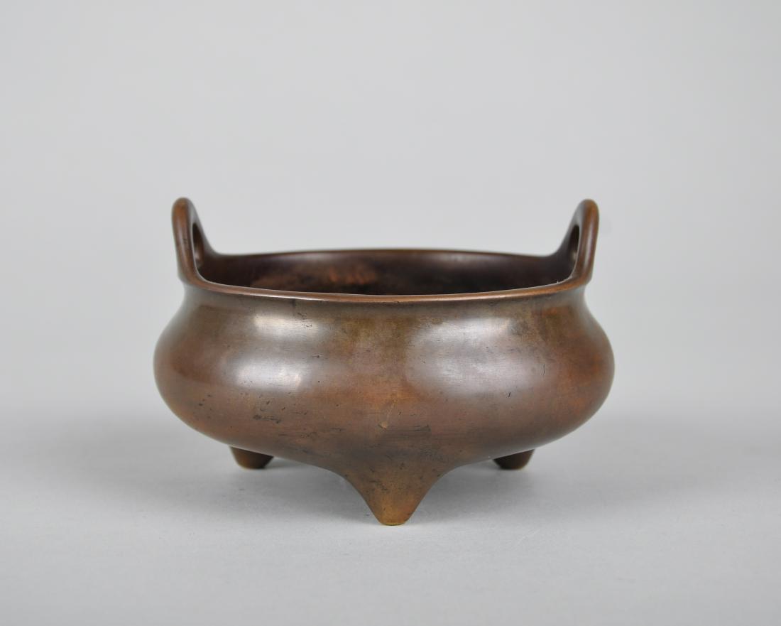 A BRONZE TRIPOD CENSER, XUANDE MARK, BUT EARLY QING: A Bronze Tripod Censer, Xuande Mark, But Early Qing Dynasty; H7.5cm, Dia13cm; Weight1301.8g Provenance: Acquired in Germany
