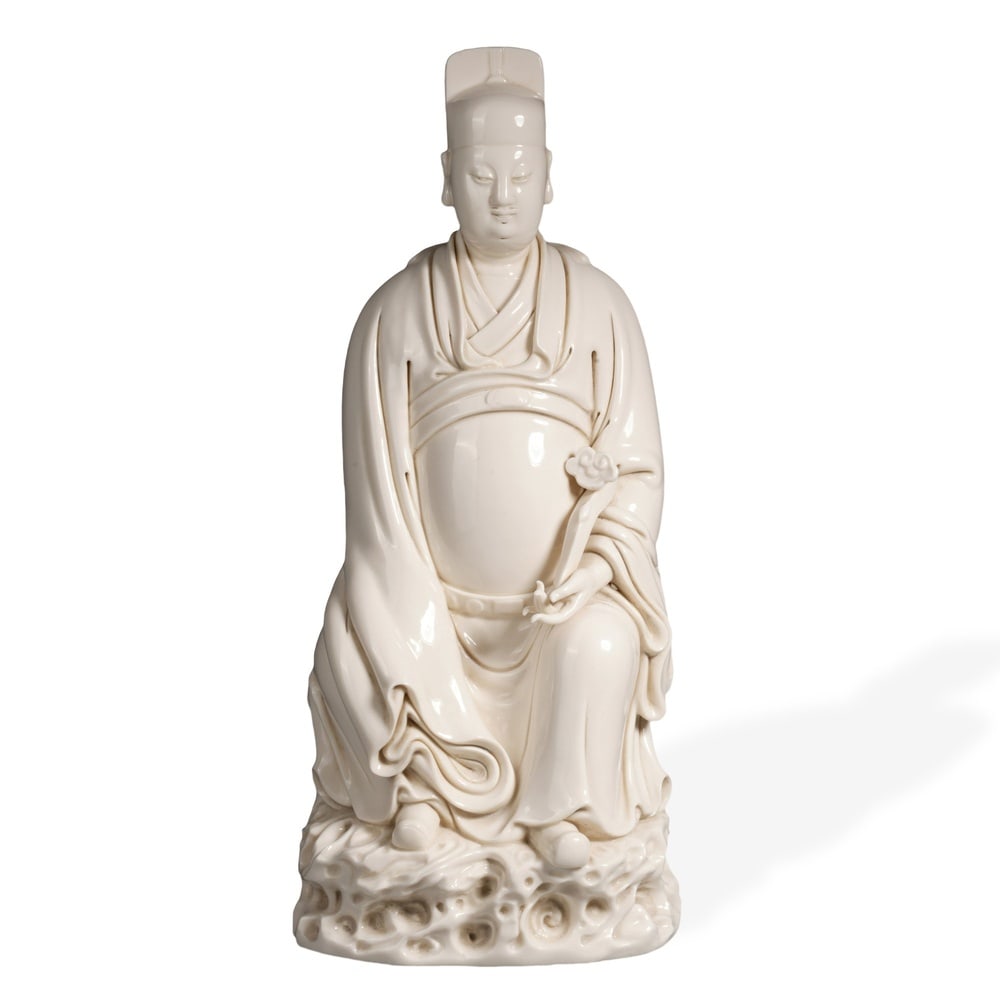 MING DEHUA FIGURE OF WENQUXING, STAR GOD OF LITERATURE, HE CHAOZONG MARK: 15 3/4 x 6 3/4 in (40 x 17 cm) Ming Dehua Figure of Wenquxing, Star God of Literature, He Chaozong Mark Dimensions: H: 15 3/4 in (40 cm); W: 6 3/4 in (17 cm) This commanding standing figure exemplifie