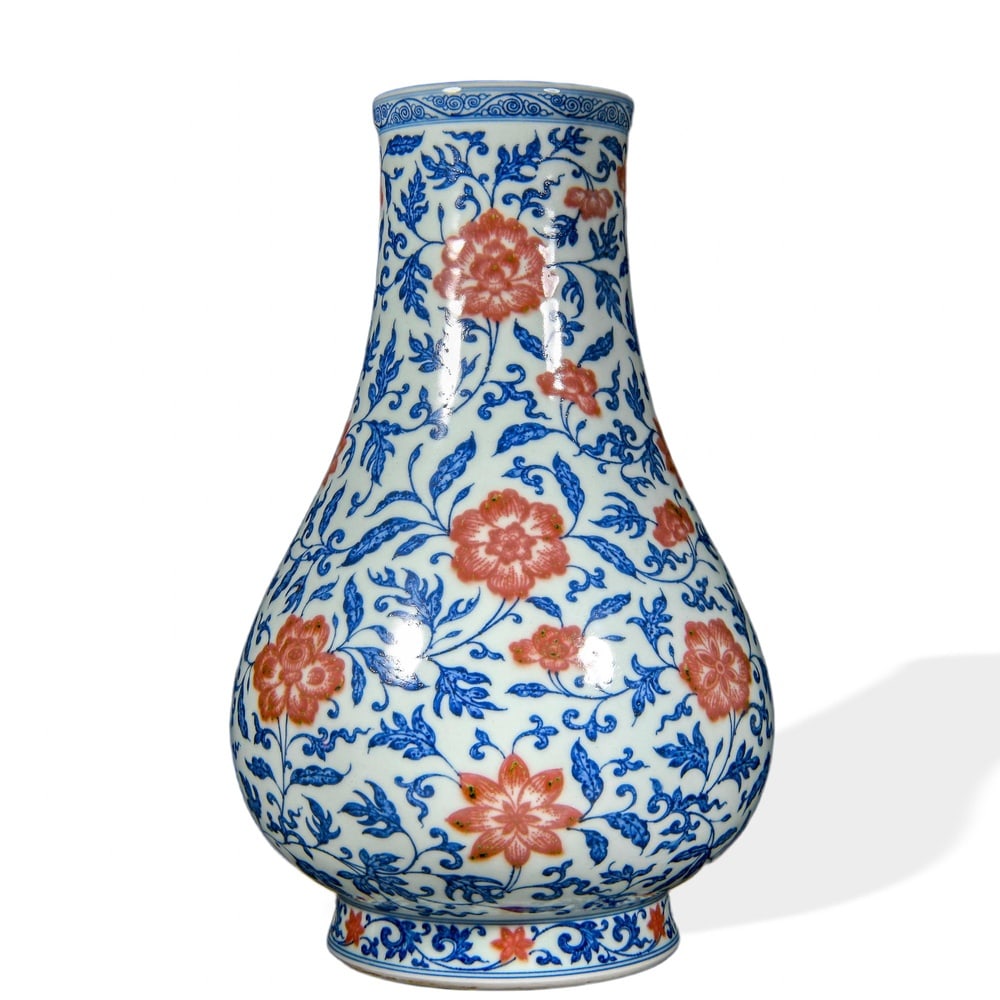 YONGZHENG UNDERGLAZE BLUE AND COPPER-RED 'LOTUS AND PEONY SCROLL' WIDE-MOUTHED VASE: Yongzheng Underglaze Blue and Copper-Red 'Lotus and Peony Scroll' Wide-Mouthed Vase Dimensions: H: 13 in (33 cm); W: 8 1/4 in (21 cm) This handsome vase exemplifies one of the most demanding combinati