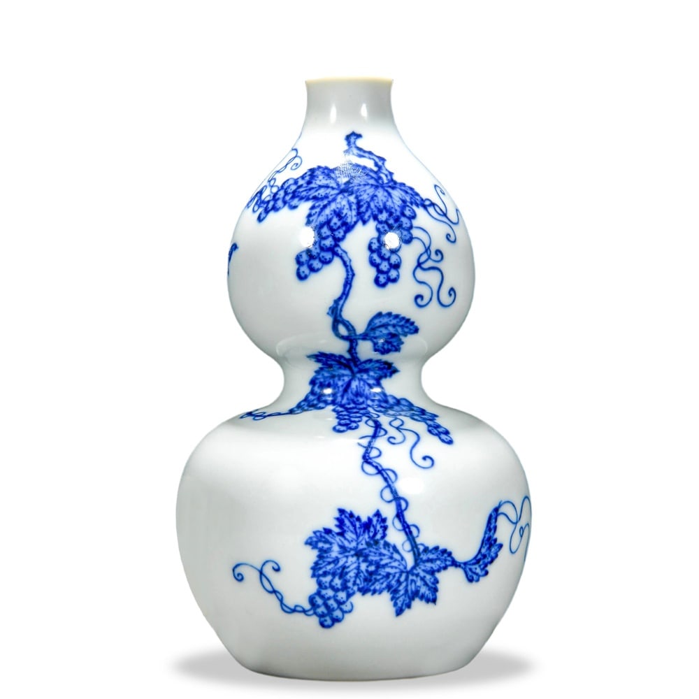 YONGZHENG BLUE AND WHITE 'GRAPE VINE' DOUBLE-GOURD VASE: Yongzheng Blue and White 'Grape Vine' Double-Gourd Vase Dimensions: H: 6 1/4 in (16 cm); W: 3 1/2 in (9 cm) This small double-gourd vase (hulu ping) embodies the quiet refinement that defines the