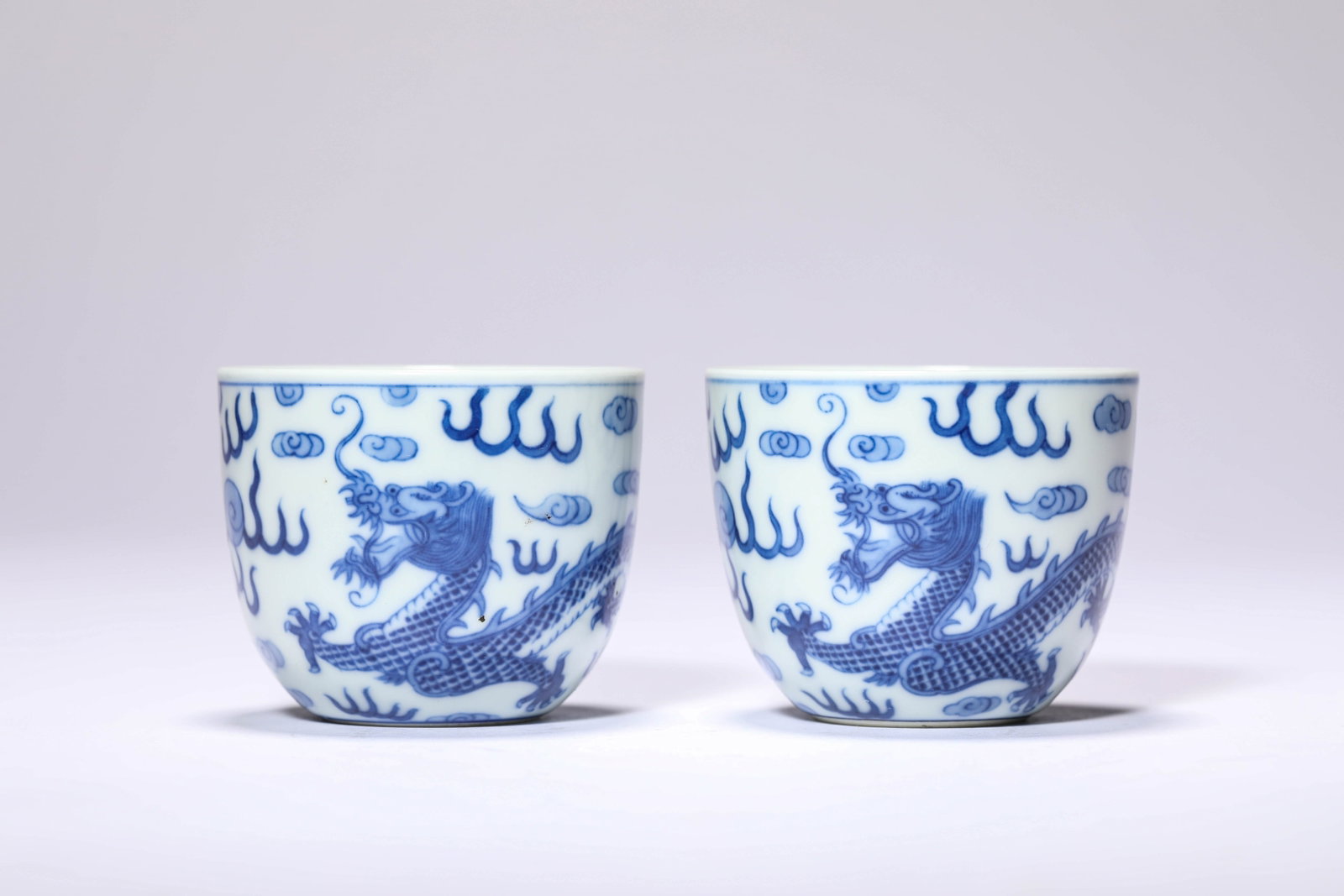 Pair of Blue and White Dragon Chasing Pearl Pattern Cups: Pair of Blue and White Dragon Chasing Pearl Pattern Cups; Mark/Period: Guangxu mark, Qing dynasty; Material: Porcelain; Dimensions/Weight: Width 6.1 cm Height 5.1 cm