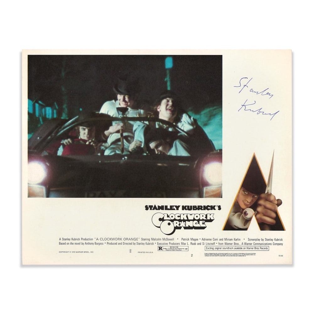 STANLEY KUBRICK SIGNED "A CLOCKWORK ORANGE" LOBBY CARD: 10 x 8 in (25.5 x 20.3 cm) This 1972 Warner Bros. lobby card was produced for the theatrical release of A Clockwork Orange, Stanley Kubrick's groundbreaking adaptation of Anthony Burgess's novel. Rega