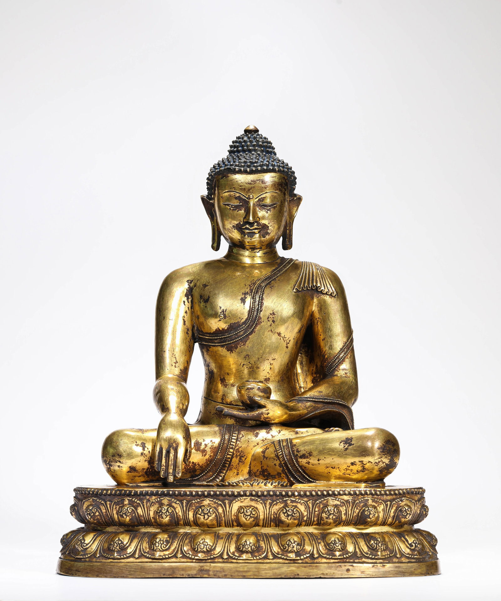 Gilt-Copper Figure of the Medicine Buddha: Gilt-Copper Figure of the Medicine Buddha. Material / medium: Copper figure. Weight: 5.55 kg. Length: 26.1 cm. Width: 17.6 cm. Height: 32.8 cm.