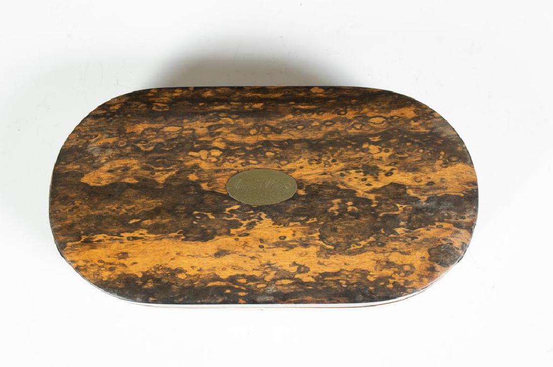 English Coromandel and Rosewood Jewel Box: Oval in form, the top and sides veneered in Coromandel wood, the bottom in Rosewood, with oval brass monogrammed "Mattie A.Whittelsey, " with brass escutcheon and lock marked Patent. 1.75 in.h.&n