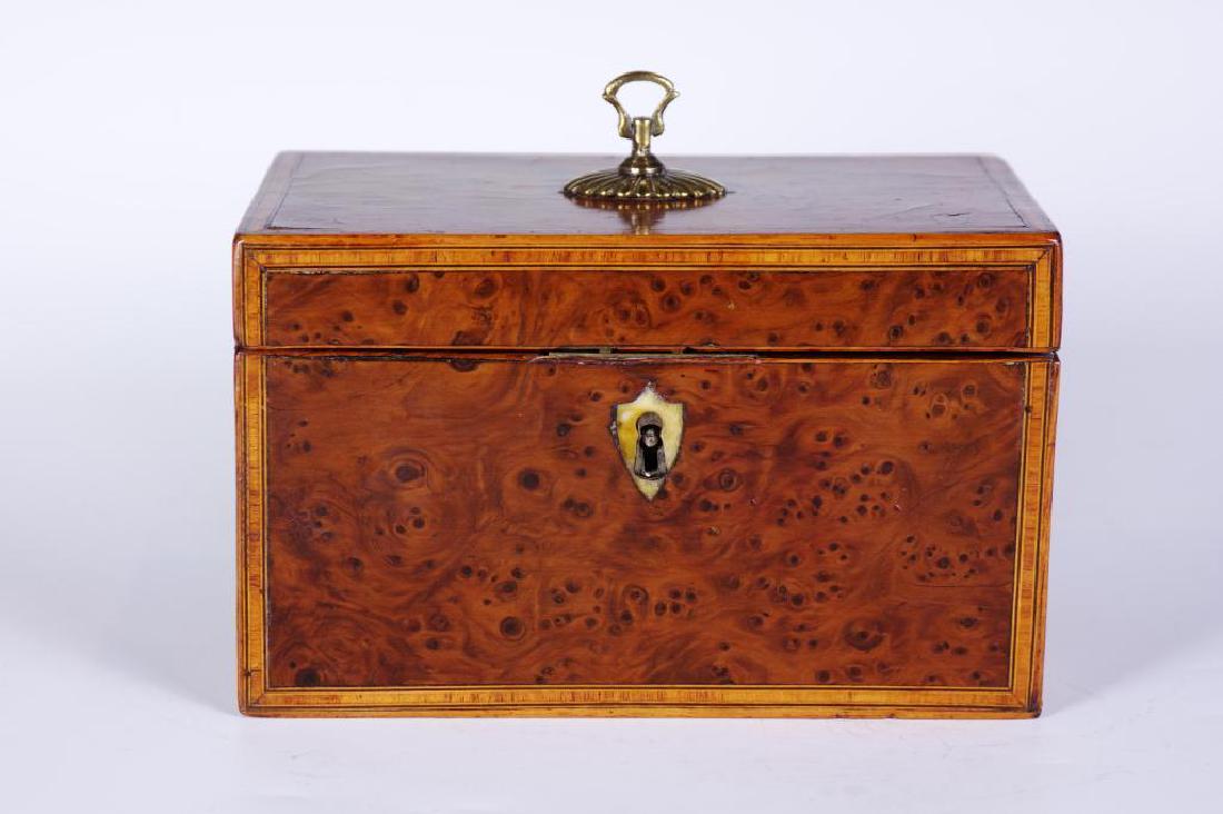 Antique Burl Wood Georgian Period Tea caddy: Oblong wood box of bird's eye burl wood with blond wood inlaid banding on edges, bone escutcheon at lock, no key, hinged lid with plated loop finial. Interior having two compartments with re