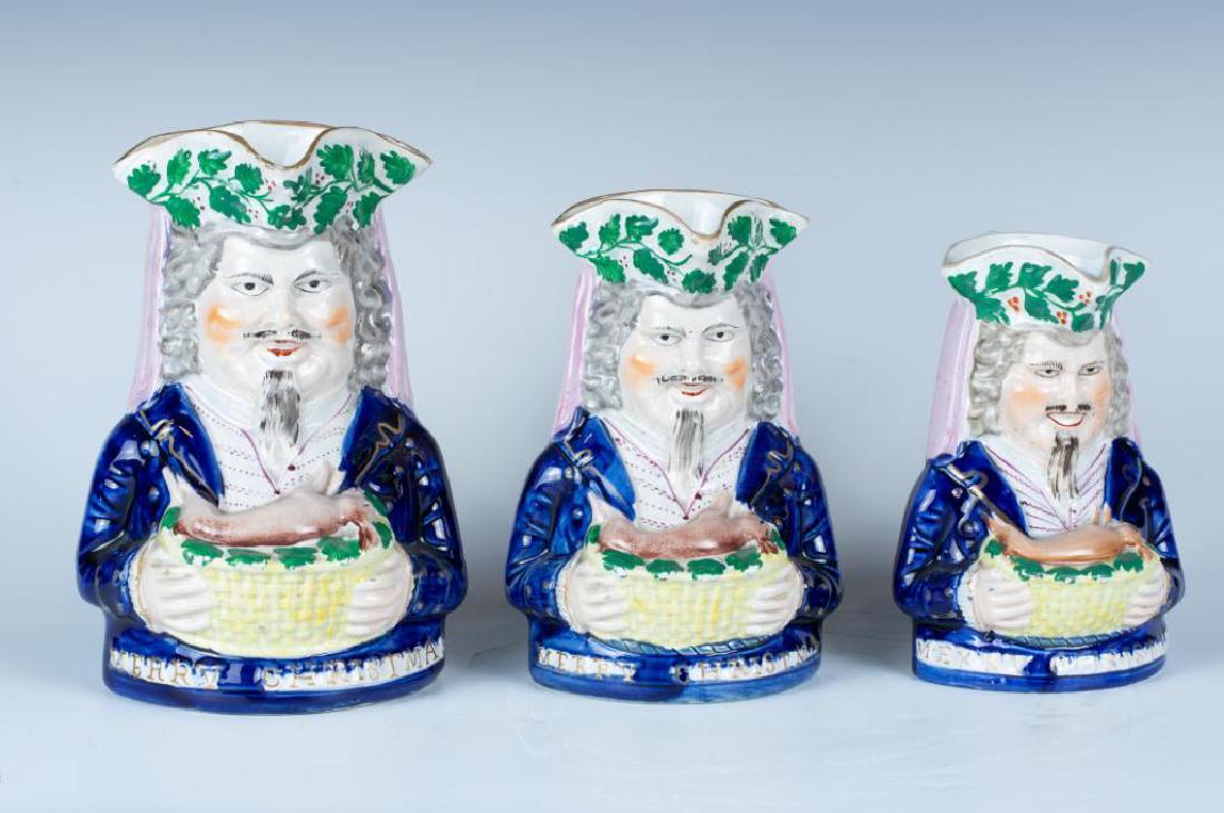 A Graduated Set of Staffordshire Merry Christmas Toby: Wearing a tri-corn hat and holding the Holly Rabbit dinner, wearing the blue coat, raised gilt lettering along front base "Merry Christmas", all in good condition with light chips to hat rims. 8-1/2"T