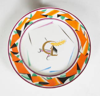 Russian Soviet Era Porcelain Plate: Hand painted 9.25 plate, center having a gilt sickle and wheat within and colorful orange border design. Verso with over glaze blue sickle and cogwheel mark and date 1919. Very good condition.