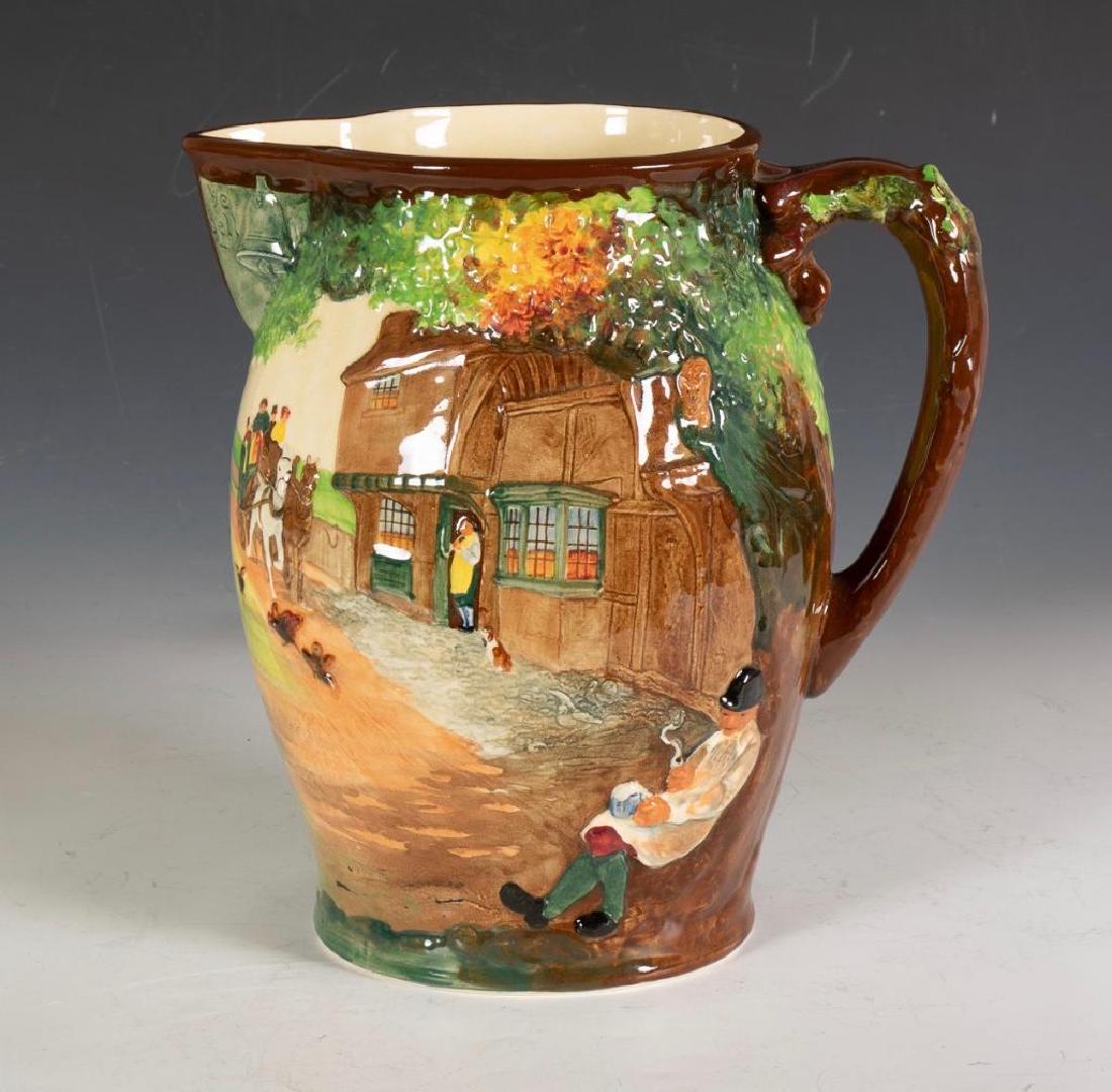 Royal Doulton Dickens Series Regency Coach Jug: Decorated in relief with a horse drawn coach arriving at a country inn. Signed and numbered 312 from an edition of 500. 11 in. h. x 10 in. w. Condition: In good condition with no damage or repai