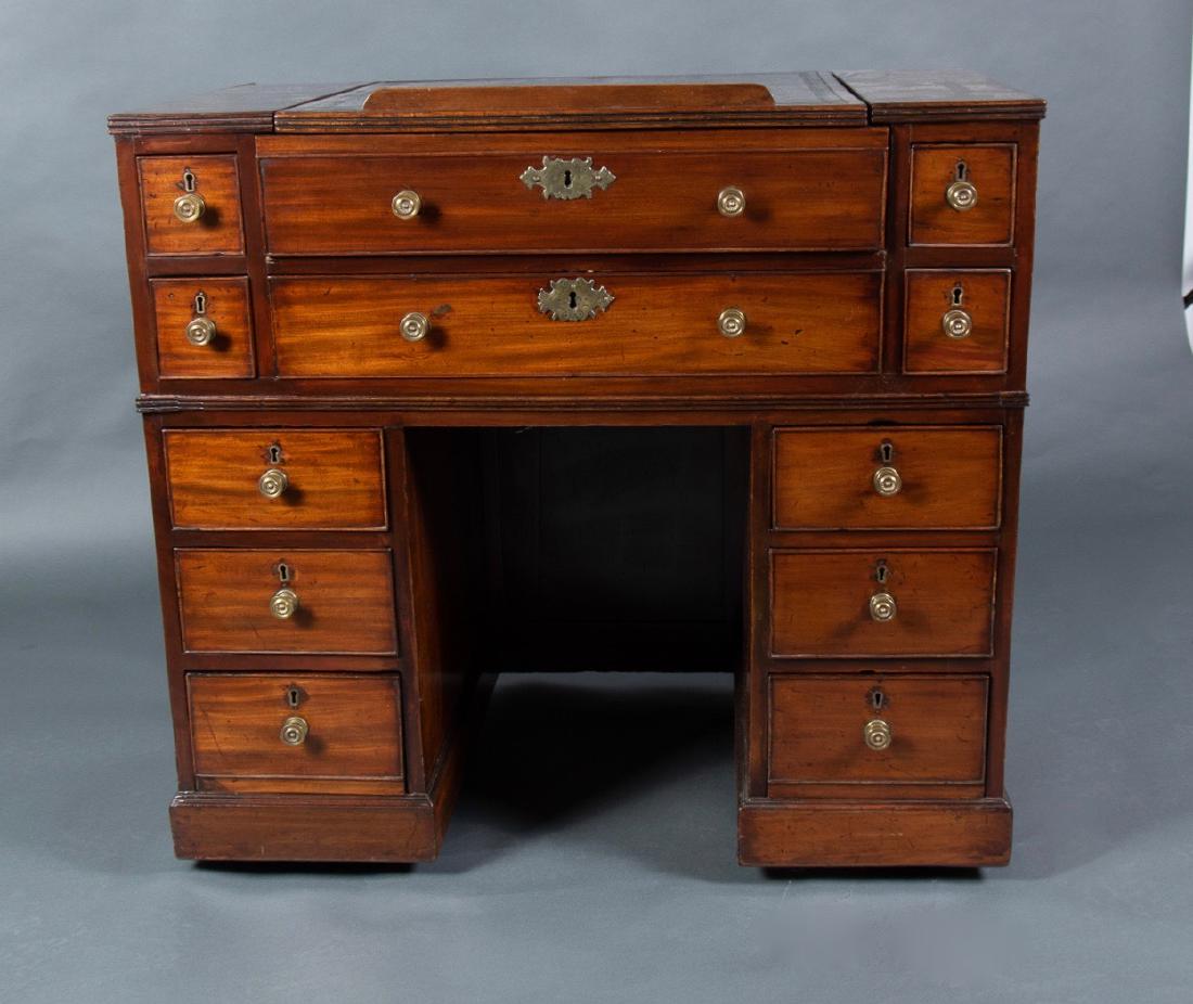 Georgian Mahogany Kneehole Architect's Desk: Squared top with adjustable lift drawing surface with inset green leather, over a long drawer, with 4 short drawers flanking, the lower section with two banks of three drawers. 34 x 37 x 22
