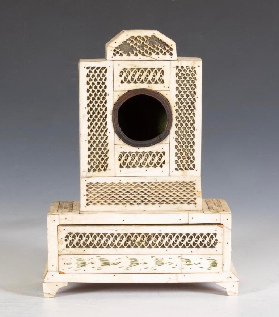 Russian Arkhangelsk Walrus Bone Clock Watch: In the form of a Secretary Bookcase, in pierced bone over metal foil,the lower section with a drawer, on a bracket base. 9.5 x 7 x 3.5 in. 