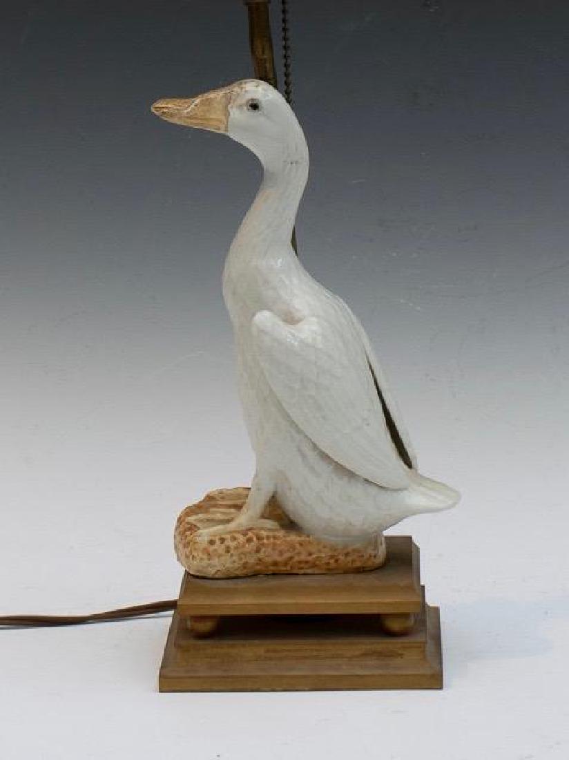 Chinese Porcelain Figure of a Duck: In blanc de chine glaze with yellow and brown glazed feet, raised on stepped wood base. Fitted as a lamp. Duck is 9.5 in.h. Condition: some accretions to duck bill.