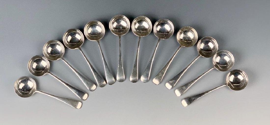 Sterling Silver Spoons, Sheffield, Dated 1837: William Hutton and Sons, Ltd maker, twelve bouillon spoons with fiddle back handles. 5.75 in.l. 15.36 oz. troy. Condition: Normal wear commensurate with age and use.