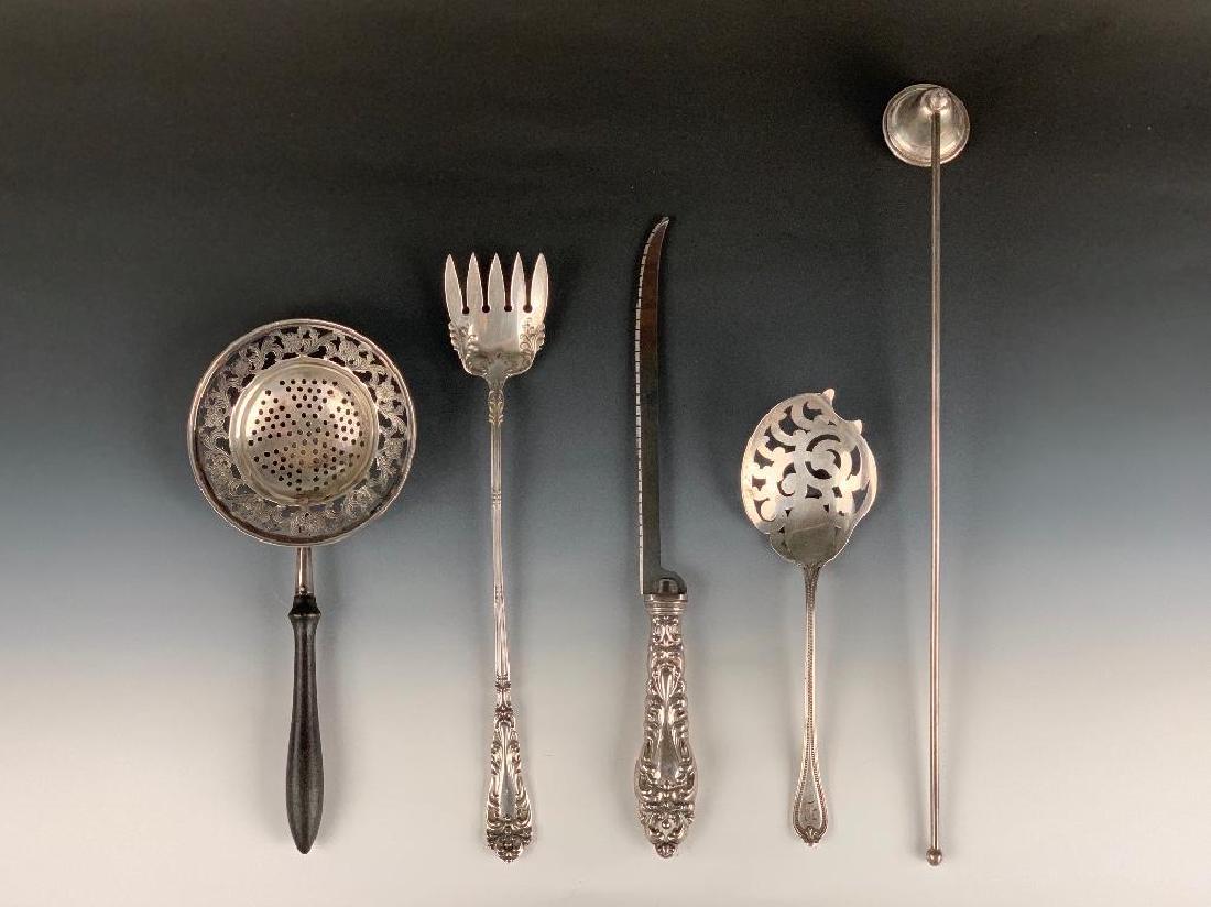 Assorted lot of Sterling Silver: Comprising; Towle reticulated lemon server in Old Newbury pattern, monogrammed, a repousse handle filet knife, an Amston sterling long handled sardine fork, a reticulated tea strainer with e