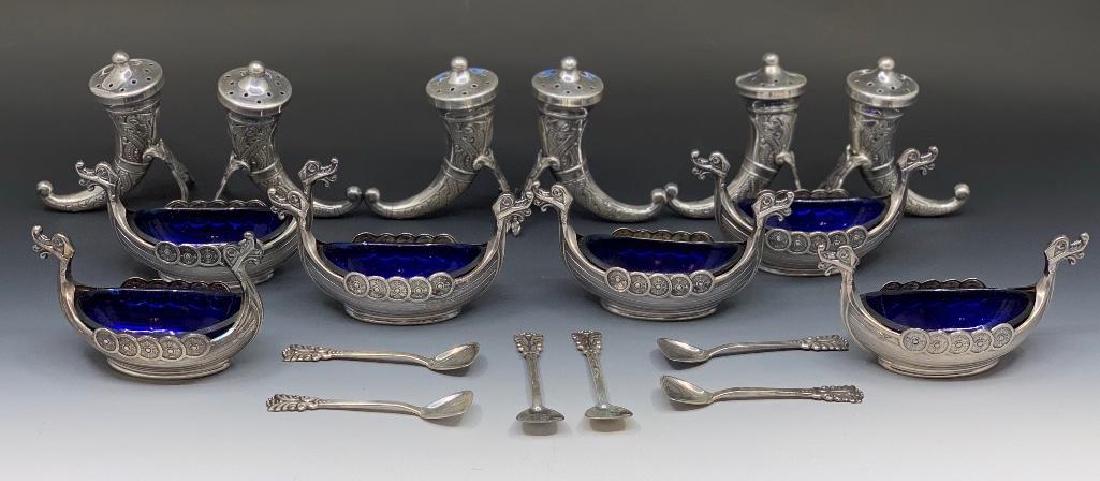Norwegian Silver Salt Cellars and Pepper Shakers: Six silver Viking ships with cobalt blue glass liners and sterling spoons and six horn pepper shakers. Stamped .925 S.Sterling Norway. Salts 3.5 in. l. peppers 2.5 in. h. 7.39 oz. troy&nbs