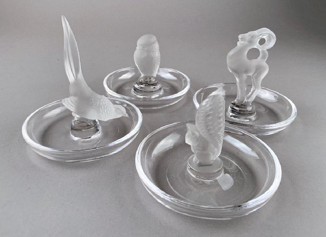 Four Lalique Cristal Ring Trays: Comprising Ram, Pheasant, Bird and Squirrel. Each signed Lalique France. 4.5 in.h. tallest. Condition: Good
