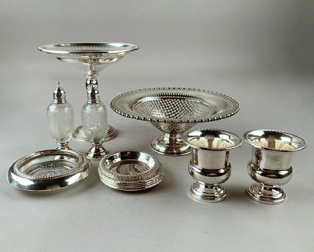 Assorted lot of American Sterling Silver: Comprising; reticulated compote(weighted) pair of cigarette urns,(weighted) seven small dishes, glass coaster with silver rim, plated reticulated footed dish, and pair of etched glass shakers with sil