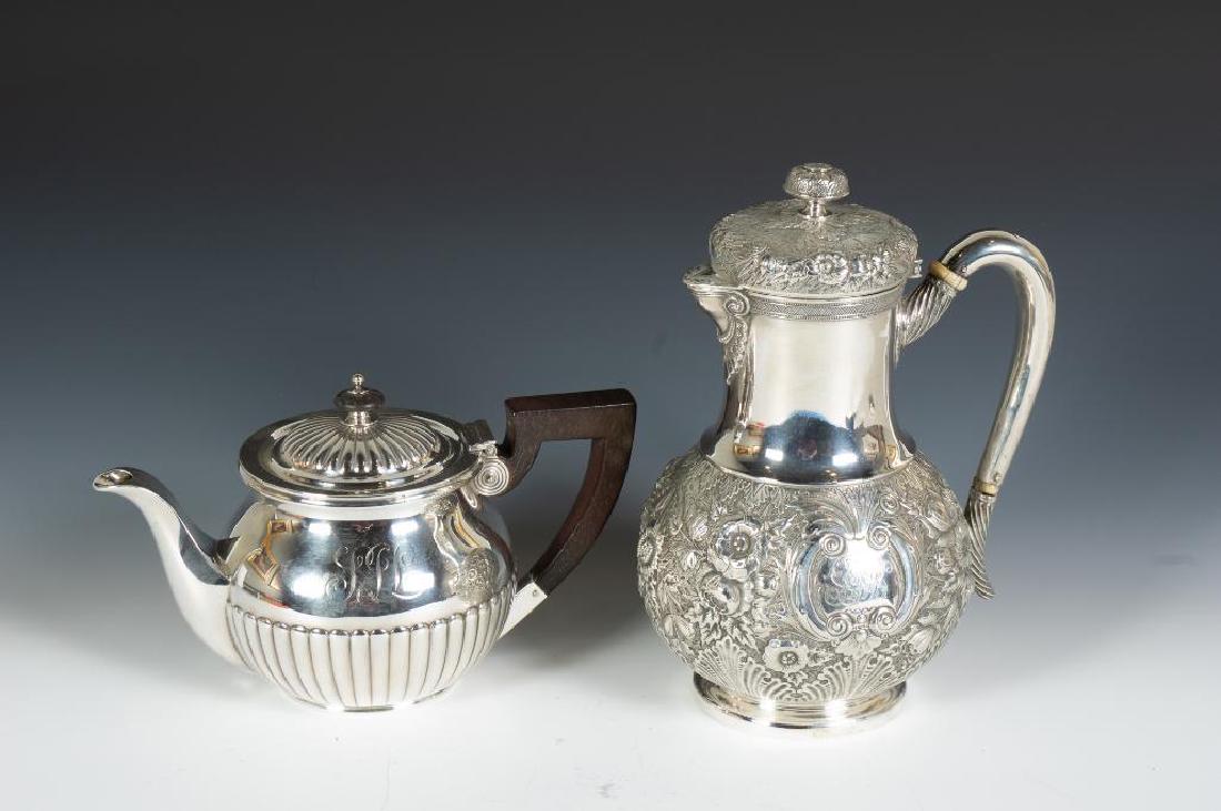 Two Tiffany and Co. Sterling Silver Teapots: With cylindrical neck and bulbous base, In a repousse floral pattern, the scroll handle with ivory coolers, monogrammed, together with a short teapot with gadrooned decoration and ebony handle 16
