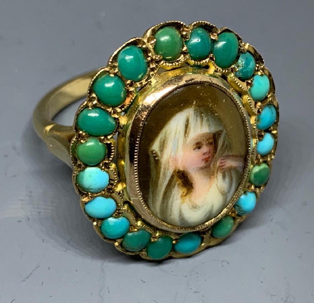 Victorian Antique Turquoise and Enamel Ring: Hallmarked 9c yellow gold ring set with a bezel set oval portrait miniature of a beauty, surrounded by small round turquoise cabochon stones. Approx 4.4 dwt, approx 6.9 grams, approx 6.25. Condition: