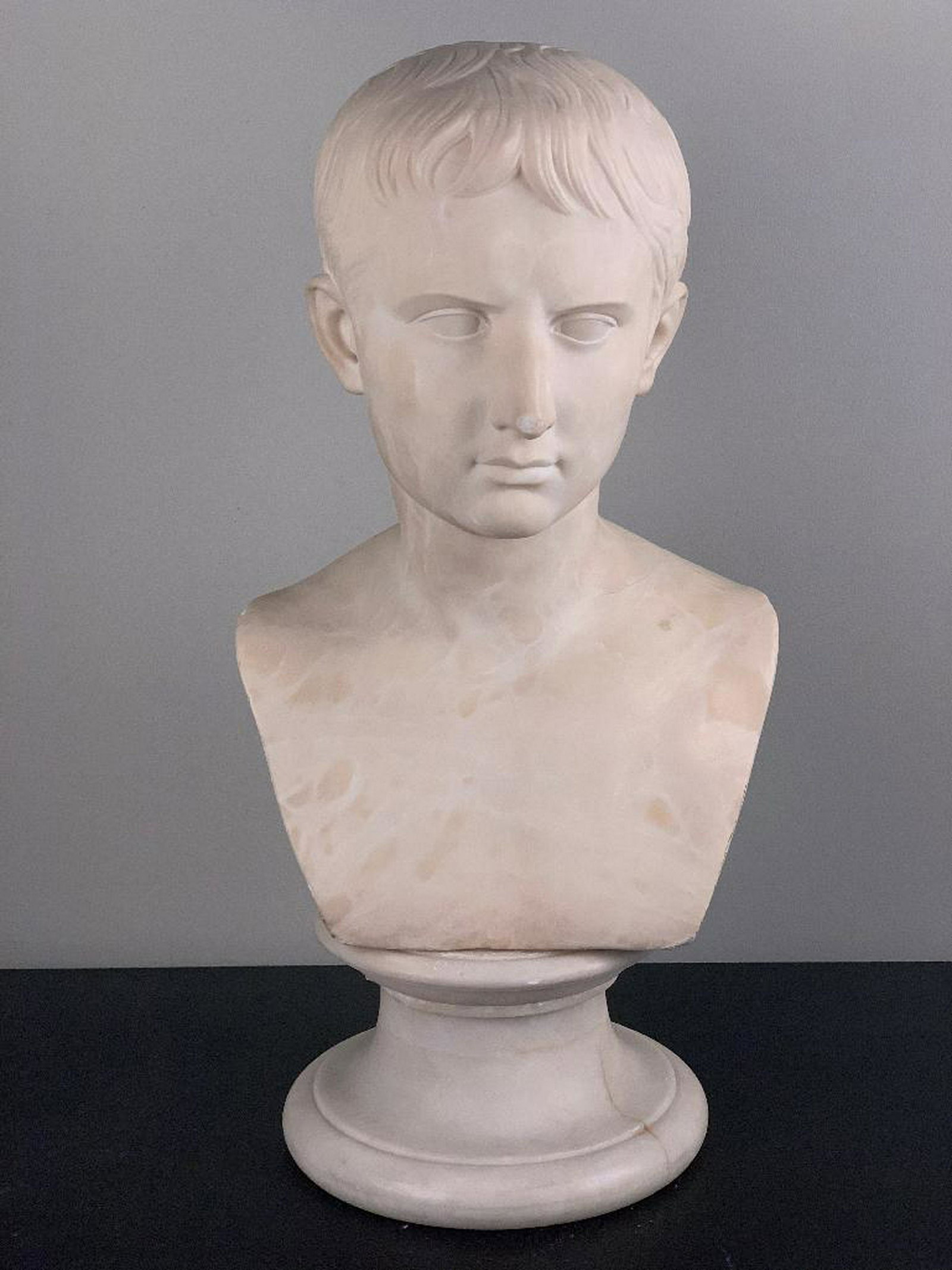 After Antonio Canova (Italian 1757-1822) Young Octavian: After Antonio Canova( Italian 1757-1822) Bust of the Young Octavian, carved alabaster on matching socle, inscribed "Made in Italy". 22.5 x 10.5 x 9 in. Condition:
