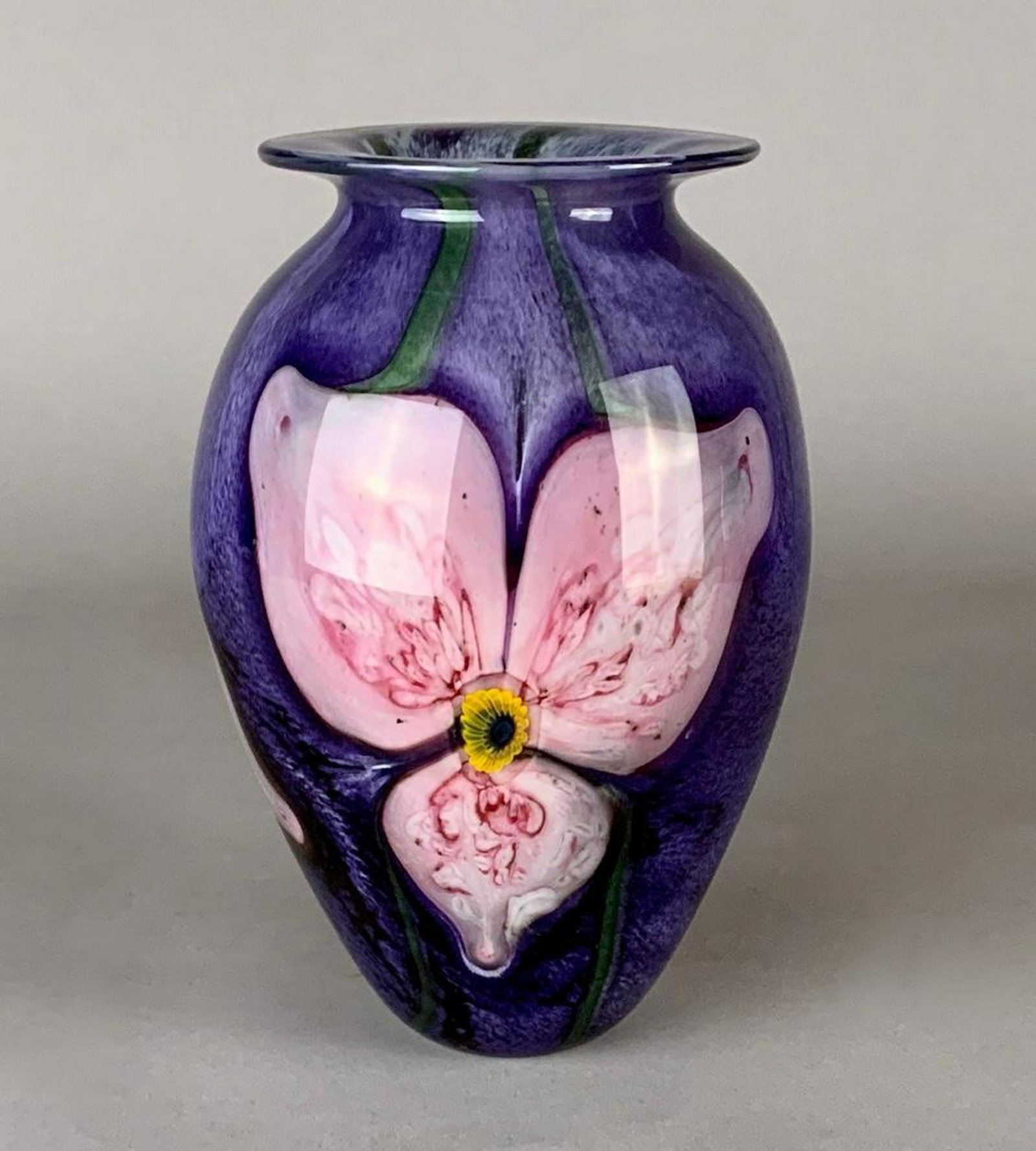 Robert Eicholt Art Glass Vase: Of baluster form, internally decorated with pink floral forms on a striated purple and green ground. Signed Eicholt, 1995, ULFL. 8.75 in.h. x 6 in w. at widest. Condition: Very good with no damage or 